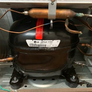 LG compressor in a refrigeration unit, showcasing repair and replacement services for marine and residential appliances by Appliances of Broward.