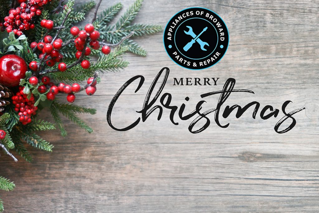 Appliances of Broward holiday greeting with "Merry Christmas" text, surrounded by festive decorations including red berries, pine branches, and a logo for marine appliance repair services.